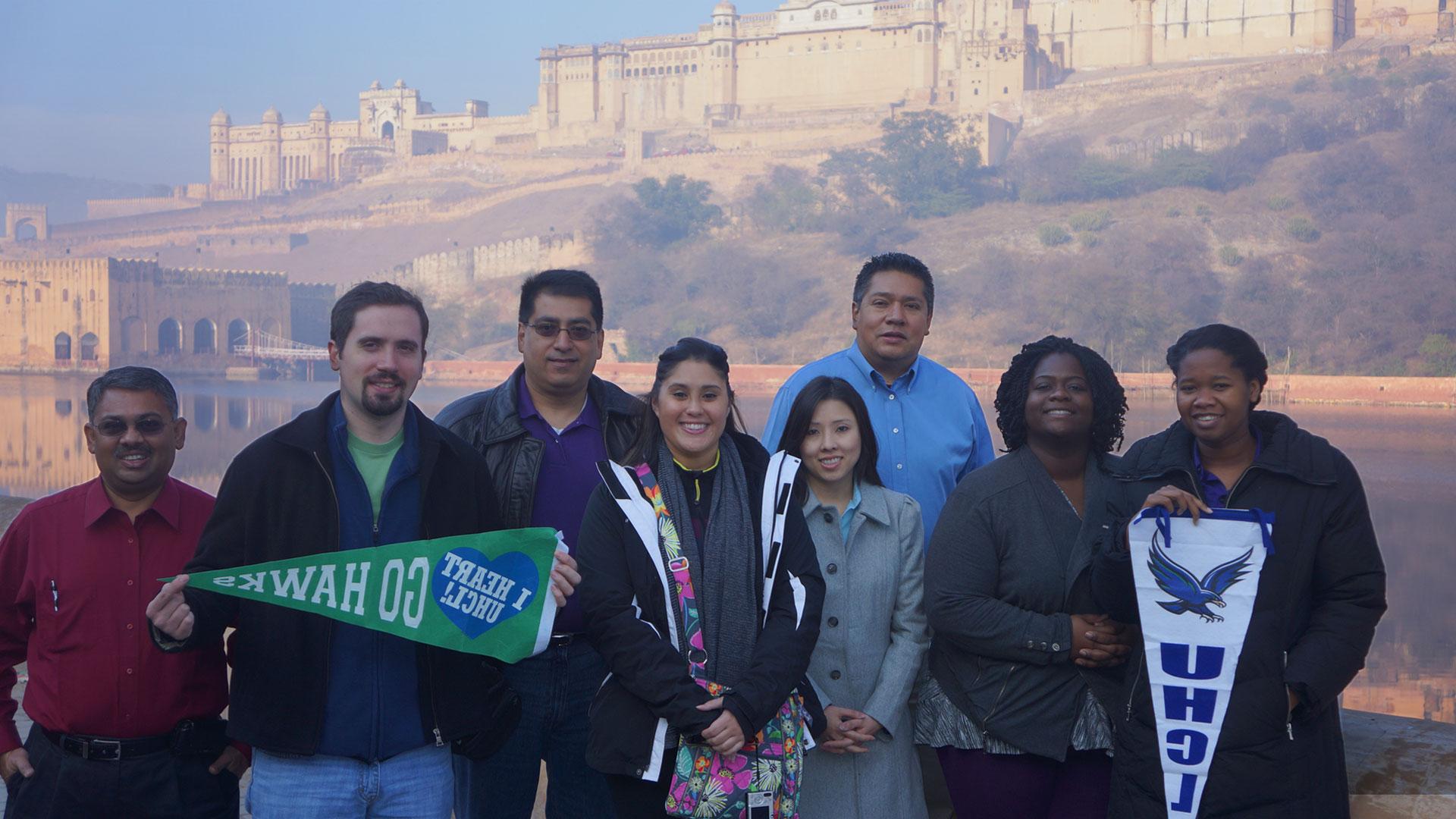 Students holding UHCL penants in Oman